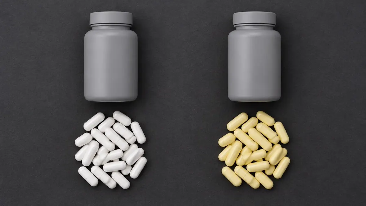 Precise two-column editorial flat-lay with identical neutral supplement containers and two sets of capsules